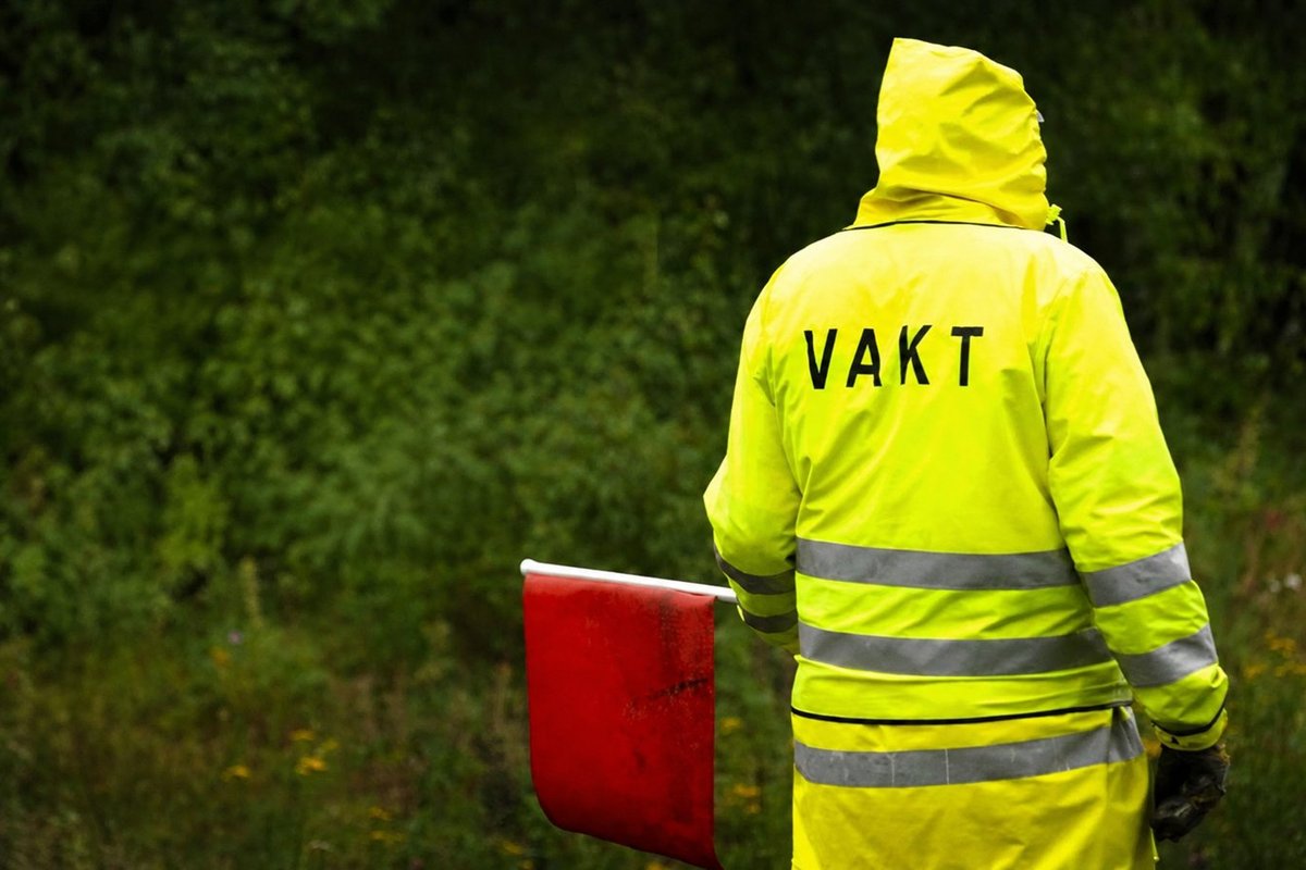 Flaggvakt som dirigerar trafiken vid ett vägarbete i Sundsvall
